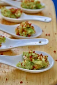 Avocado with prawns, lime, coriander and bacon bits