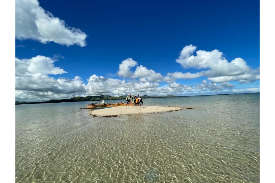 lumayag sandbar boat and family on sand bump