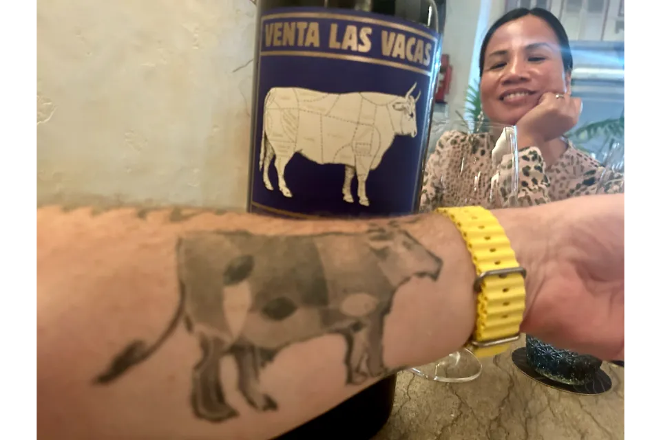 cow tattoo and wine asador