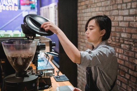 Free Barista Working with Coffee Grinder in Cafe Stock Photo