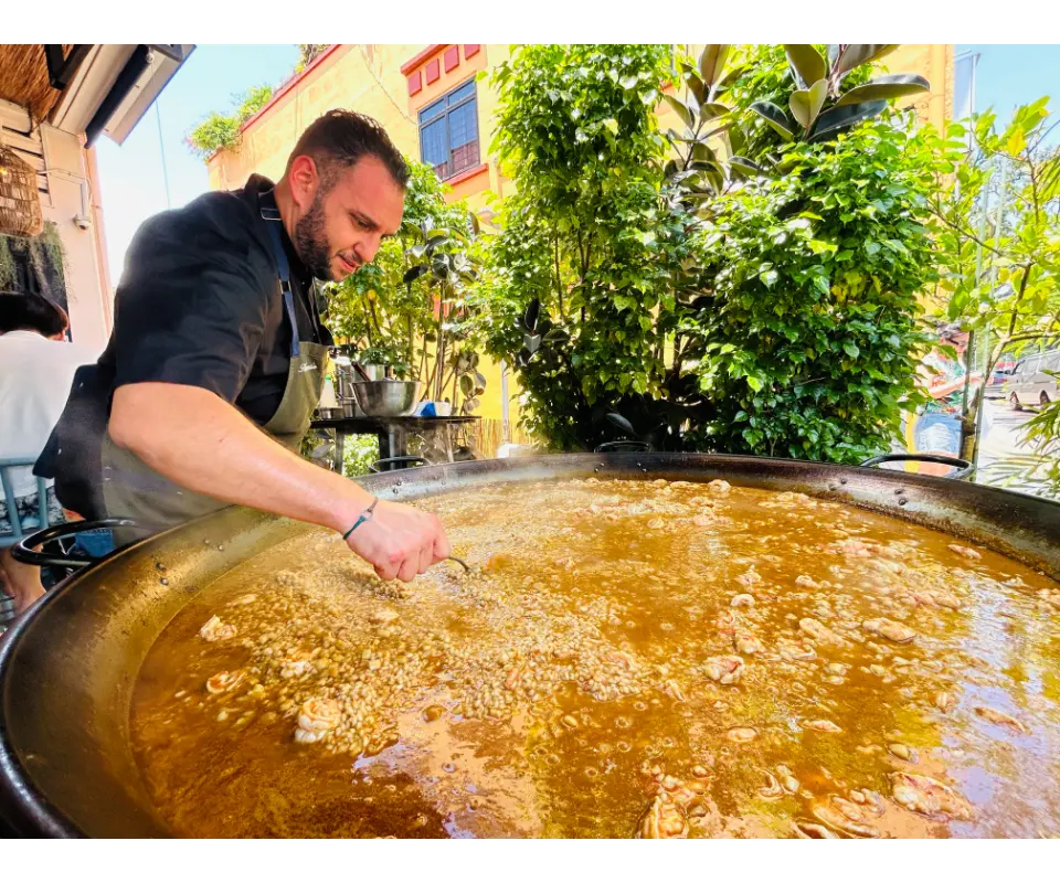 paella world day eat spain drink spain next door spanish cafe chef stirring