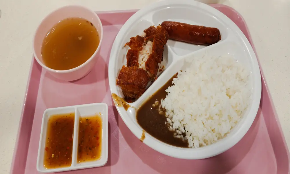 Lechon crispy pork belly with rice and Filipino sausage at SJD Carinderia