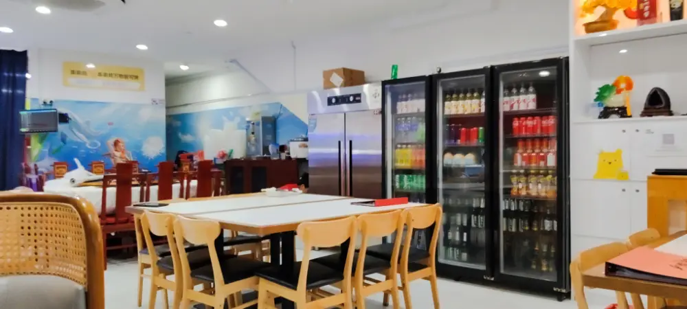 Interior of Happy Dining Seafood restaurant with fridges and family seating