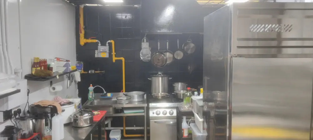 Ritch’s spotless kitchen with black tile wall